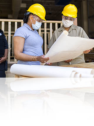 Two volunteers looking at a plan